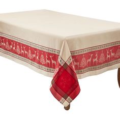 the table cloth is red and white with deers on it, along with a wooden base