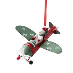 a christmas ornament shaped like an airplane with a snowman on the wing