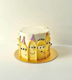 a yellow cake with three faces on it