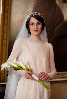 a woman in a wedding dress holding flowers