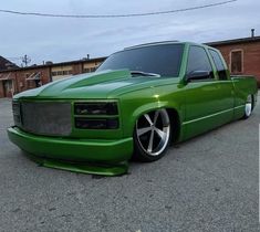 a green truck parked in a parking lot