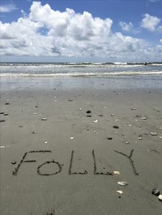 the word holly written in sand on a beach