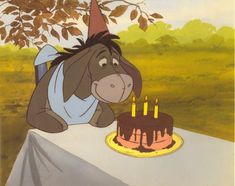 the donkey is looking at the birthday cake