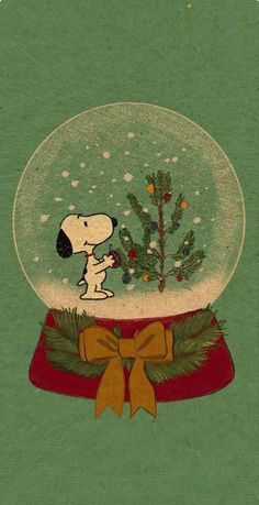 a snow globe with a snoopy christmas tree in it and a dog on top