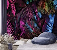 a living room with purple and blue wallpaper that has tropical leaves on the walls