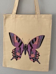 "Hand painted, canvas tote bag. Approximately 13\"X15.5\" with 12\" handle drop. Purple Butterfly design." Artsy Hand Painted Canvas Bag For Daily Use, Artsy Hand Painted Tote Canvas Bag, Artsy Hand Painted Canvas Tote Bag, Artistic Canvas Shopping Bag, Artistic Canvas Gift Bag, Cotton Hand-painted Bags For Daily Use, Daily Use Hand Painted Canvas Bags, Hand Painted Canvas Tote Bag, Hand Painted Cotton Tote Canvas Bag