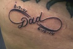 a tattoo with the word dad written in cursive font