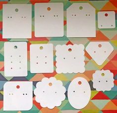 white tags and tags are laid out on a colorful background with geometric shapes around them