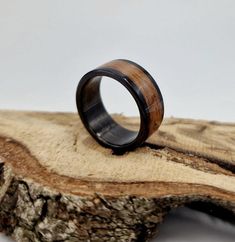 a wooden ring sitting on top of a piece of wood