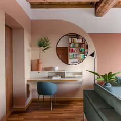 a living room with pink walls and wooden floors