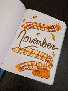 an open notebook with the words november written on it