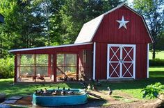 a red barn with a blue boat in the yard