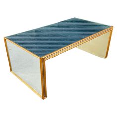 a blue and gold coffee table with mirrored sides