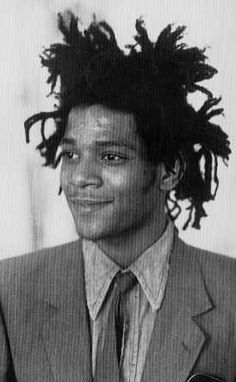 a black and white photo of a young man with dreadlocks on his hair