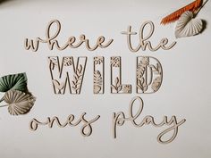 the words where the wild ones play are made out of cutout wood and paper