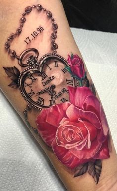 a rose and an old pocket watch tattoo on the arm