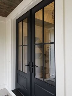 a black double door with glass on the outside