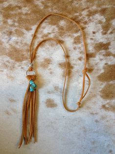 Enjoy wearing this lightweight, adjustable tassel and faux turquoise necklace. Adjustable Tassel Necklace For Festivals, Adjustable Tassel Necklace With Fringe For Festivals, Adjustable Fringe Tassel Necklace For Festival, Bohemian Adjustable Tassel Necklace With Fringe, Adjustable Bohemian Tassel Necklace, Adjustable Dangle Tassel Necklace For Festivals, Adjustable Fringe Necklace For Beach, Bohemian Long Tassel Necklace With Adjustable Chain, Bohemian Turquoise Lariat Necklace With Adjustable Chain