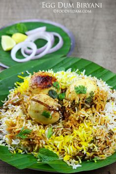 an image of food on a plate with rice and vegetables in the middle, along with other foods