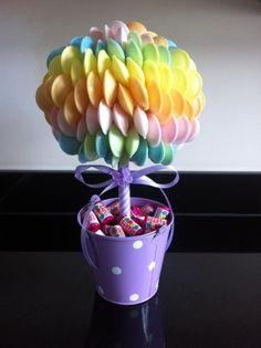 a cup filled with candy sitting on top of a table