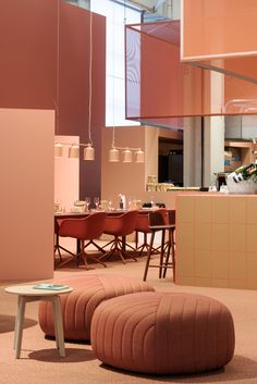 a room filled with furniture and pink walls