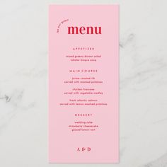 a pink menu card sitting on top of a white table