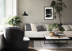 a living room filled with furniture and plants