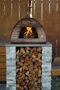 a brick oven with firewood stacked in it