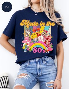 a woman wearing a t - shirt that says made in the 80's with cartoon characters