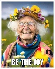 an old woman with flowers on her head and text that reads, be the joy