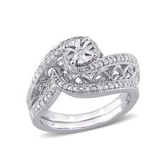 a white gold ring with diamonds on the sides and an intricate design in the center