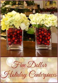 three vases filled with flowers and berries on top of a table next to a christmas tree