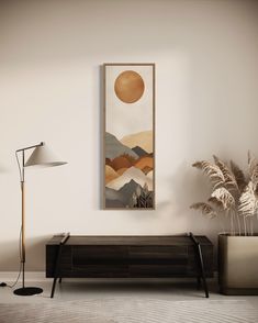 an abstract painting hangs on the wall next to a modern dresser and lamp in a living room