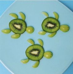 three slices of kiwi sitting on top of a blue plate next to each other