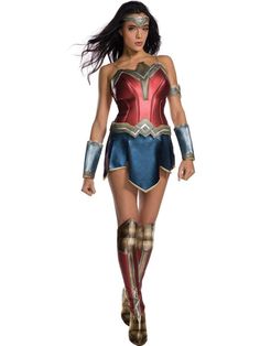 a woman dressed as wonder is walking down the street with her hands on her hips