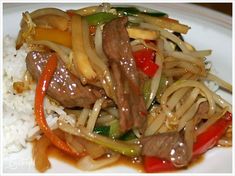 stir fry beef and vegetables with rice on a plate