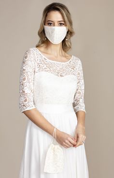 This beautiful lace face covering and sweet matching wrist bag are the perfect and practical souvenir for your special day. Hand made in the UK and created with bridal fabrics to match our wedding dresses, these are the face masks you have been waiting for. Created with 3 layers of fabric, this stylish essential is complete with soft elastic and small adjustors to ensure the perfect fit and comfort. Sold with a matching bag which can hang from your wrist to ensure safe keeping and easy access th Bridal Face Mask, Wedding Dress Crafts, Tiffany Rose, Wrist Bag, Pregnant Wedding, Pregnant Wedding Dress, Bridal Fabric, Party Kleidung, Romantic Lace