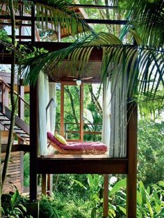 a canopy bed in the middle of some trees