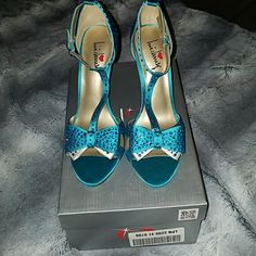 a pair of blue shoes sitting on top of a box