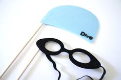 a pair of black glasses and a blue hat with the word dive on it