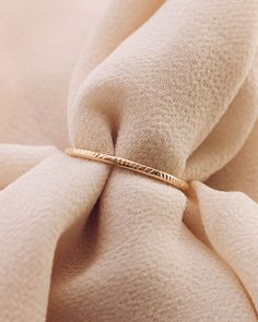 Rays Dainty Ring Band 14K Gold Filled Size 3-12 Width: 1.2mm Please note there are slight color variations or an appearance of a seam where the joints of the ring has been soldered. Due to their handmade nature, keep in mind that solder marks are visible and normal to have. Minimalist 14k Gold Ring With Decorative Band, Dainty Diamond Cut Round Band Rings, Minimalist Yellow Gold Rings With Decorative Band, Minimalist Yellow Gold Ring With Decorative Band, Minimalist Promise Ring With Decorative Band, Stackable Gold Band Rings, Stackable Band Gold Rings, Delicate Gold 14k Band, 14k Gold Band Ring For Gift