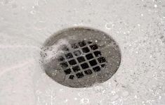 a drain that has water coming out of it and some sort of square design on the side