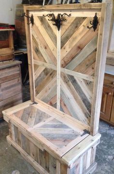 a wooden bench made out of pallet wood in a room with drawers and cabinets