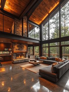 a large living room with high ceilings and floor to ceiling windows