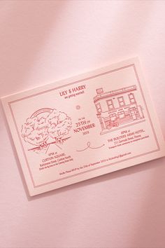 a pink envelope with a drawing of a building on it