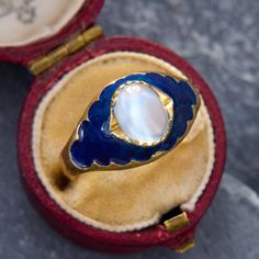 This ethereal ring is centered with an oval gem-quality moonstone cabochon. The moonstone glows atop the dark blue enamel accented shoulders. The ring has a Swiss "Three Crown" stamp. It is crafted in 18K yellow gold and is now and forever a size 9. Please note that there is some jeweler's epoxy exposed from setting the moonstone. Due to the enamel details of this ring, we are not offering resizing on this piece. Antique Engagement Rings Sapphire, Audry Rose, Cabin Door, Estate Jewelry Rings, Wedding Ring Diamond Band, Moonstone Cabochon, Diamond Dangle Earrings, Pretty Clothes, Antique Engagement Rings