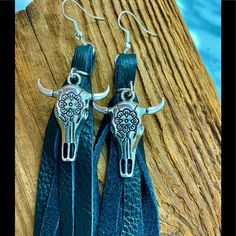 Black Leather Fringe, Skull Earrings. Cattle/ Buffalo Cowgirl Boho Chic Earrings. Compliments Will Be Lassoed Your Way Girls. These Sell Out Quickly In Our Boutique. . Wrangler Roper Jeans Outfits Boots Perfect Boho Music Festival Or Summer Rodeo . Look In My Closet For More Genuine Leather Earrings , Handmade Here In The Foothills Of Nc Made In The Usa #Westernboutique #Cowearrings Adjustable Concho Earrings For Festival, Black Fringe Jewelry For Festival, Bohemian Black Tassel Earrings As Gift, Black Tassel Earrings For Festival, Black Tassel Jewelry For Festival, Black Dangle Tassel Earrings For Festival, Summer Rodeo, Boho Music, Leather Tassel Earrings