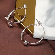 The classic circle shape, with its careful mechanism, two semicircles outline a ring, hanging between the ears at different angles will present different shapes, each angle has its beauty, concise and capable without losing the modern sense of collocation. Lookfashionable and elegantwith these gorgeous Simple Curved Earrings!! Features Small and lightweight- Wear or carry it around with you for a variety of earring options wherever you go. Wide application- Suitable for both everyday use and special occasions like parties, clubbing, weddings, and more. Perfect gift idea- Great gift to give for all ladies like mothers, grandmothers, aunts, cousins, girlfriends, and more. Excellent material-S925 ear acupuncture material, comfortable to wear, not easy to allergies. Thick electroplating is not Semi-circle Metal Hoop Earrings, Formal Circular Metal Earrings, Elegant Semi-circle Metal Jewelry, Elegant Semi-circle Metal Earrings, Elegant Open Circle Metal Jewelry, Modern Twist Hoop Earrings In Metal, Metal Open Circle Hoop Earrings, Elegant Circle Metal Earrings, Elegant Circular Metal Earrings