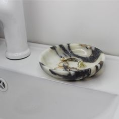 a bathroom sink with a marble bowl on it