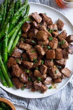 an instagram page with a plate of meat and asparagus on the side